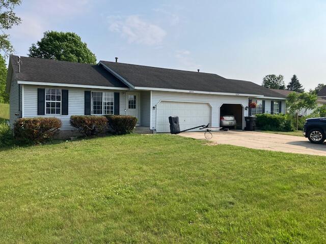 3052 143rd Ave, Dorr, MI 49323 - single story home with an attached garage, a front yard, and concrete driveway