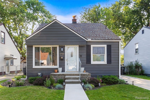 27728 Larchmont St, Saint Clair Shores, MI 48081 - bungalow-style home featuring a chimney and a shingled roof