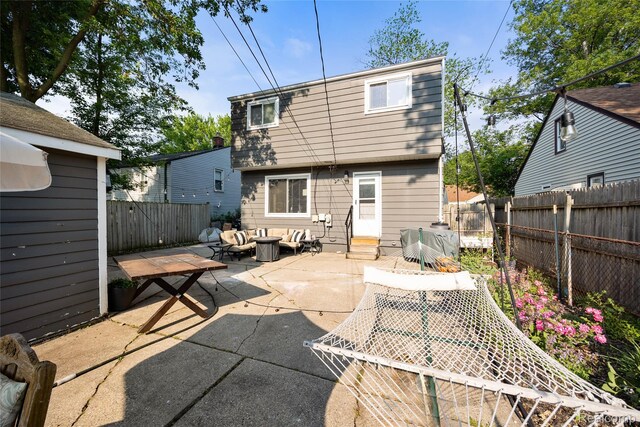 27728 Larchmont St, Saint Clair Shores, MI 48081 - rear view of property featuring a patio, an outdoor living space with a fire pit, and a fenced backyard