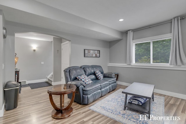 12150 W Devis Rd, West Olive, MI 49460 - living room with arched walkways, wood finished floors, stairway, and recessed lighting