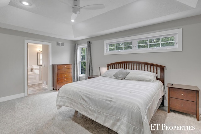 12150 W Devis Rd, West Olive, MI 49460 - carpeted bedroom with recessed lighting, a tray ceiling, connected bathroom, and a ceiling fan