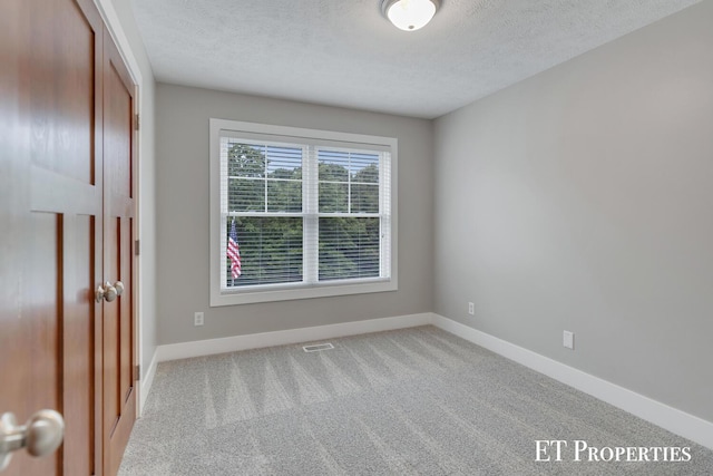 12150 W Devis Rd, West Olive, MI 49460 - unfurnished bedroom featuring a textured ceiling, carpet floors, and a closet
