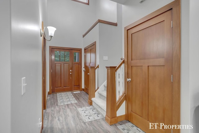 12150 W Devis Rd, West Olive, MI 49460 - entrance foyer with light wood-type flooring and stairs