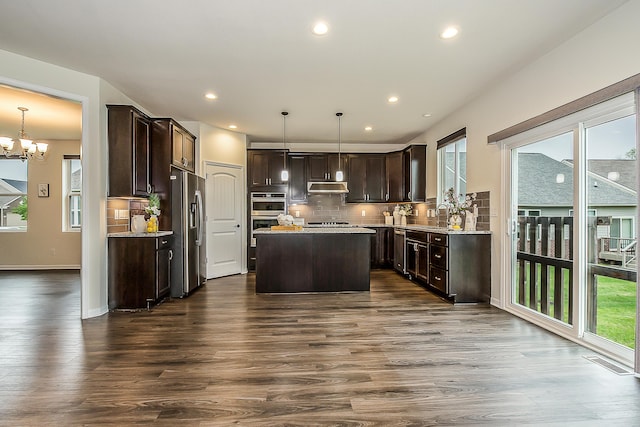 2767 St Regis Way, Ann Arbor, MI 48105 - kitchen with under cabinet range hood, stainless steel appliances, dark brown cabinets, plenty of natural light, and recessed lighting