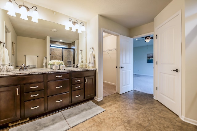 2767 St Regis Way, Ann Arbor, MI 48105 - full bath featuring double vanity, a shower stall, a spacious closet, and ceiling fan