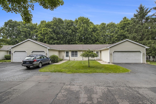 5973 Woodsong Way, Kalamazoo, MI 49009 - ranch-style home with an attached garage, asphalt driveway, and a front lawn