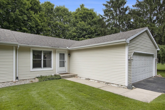 5973 Woodsong Way, Kalamazoo, MI 49009 - single story home featuring roof with shingles, a front yard, and a garage