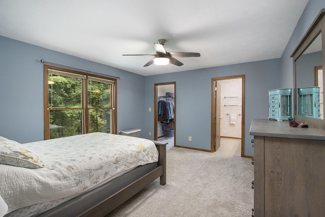 5973 Woodsong Way, Kalamazoo, MI 49009 - bedroom featuring light carpet, a walk in closet, ceiling fan, ensuite bath, and a closet