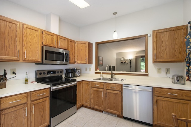 5973 Woodsong Way, Kalamazoo, MI 49009 - kitchen featuring stainless steel appliances, light countertops, and brown cabinetry