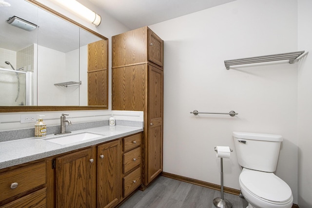 5973 Woodsong Way, Kalamazoo, MI 49009 - bathroom featuring wood finished floors, vanity, and a shower with shower door