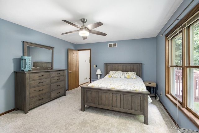 5973 Woodsong Way, Kalamazoo, MI 49009 - bedroom featuring light carpet, multiple windows, and a ceiling fan