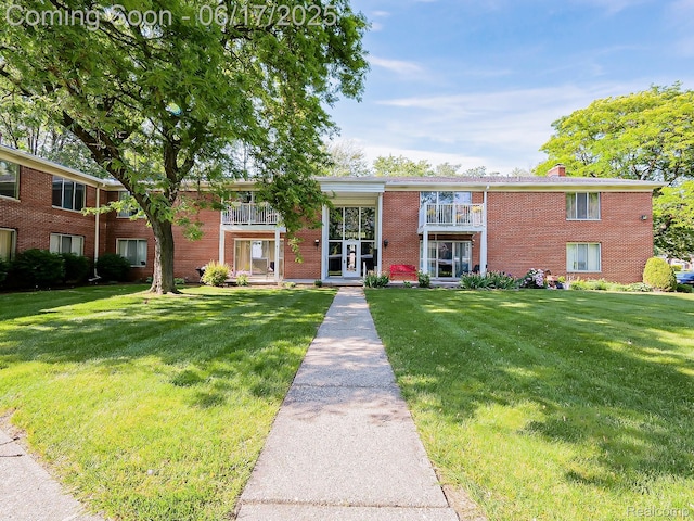 16820 Edloytom Way Unit 172, Clinton Township, MI 48038 - view of front of house featuring brick siding, a front lawn, and a chimney