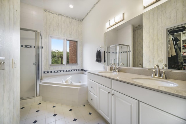 712 Dornoch Dr, Ann Arbor, MI 48103 - bathroom with a stall shower, double vanity, tile patterned floors, a whirlpool tub, and a spacious closet