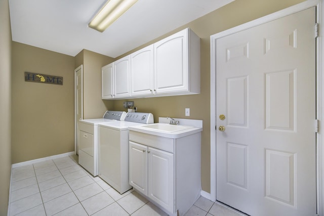 712 Dornoch Dr, Ann Arbor, MI 48103 - laundry area with cabinet space, washer and clothes dryer, and light tile patterned floors