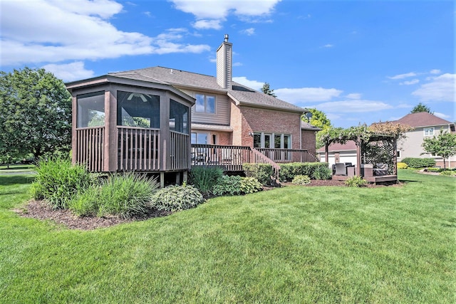 712 Dornoch Dr, Ann Arbor, MI 48103 - back of property featuring brick siding, a wooden deck, a chimney, a lawn, and a sunroom