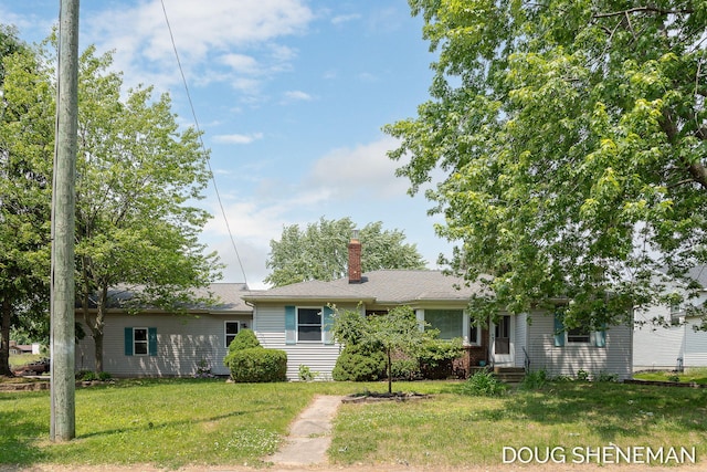 3747 Leonard St NW, Grand Rapids, MI 49534 - view of front of home with a chimney and a front yard