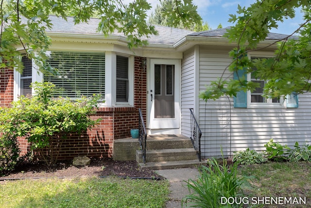 3747 Leonard St NW, Grand Rapids, MI 49534 - doorway to property with brick siding and roof with shingles