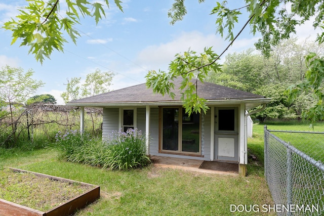 3747 Leonard St NW, Grand Rapids, MI 49534 - view of front of house featuring a shingled roof, a garden, and covered porch