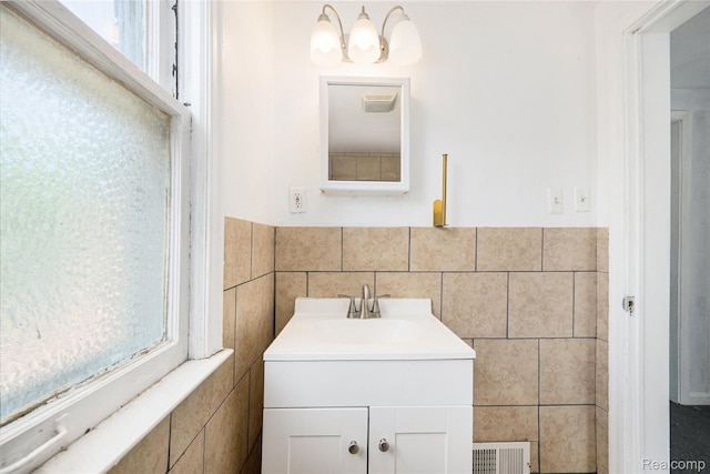 7241 W Outer Dr, Detroit, MI 48235 - bathroom with tile walls, vanity, and wainscoting