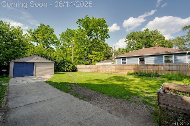 1217 E Madge Ave, Hazel Park, MI 48030 - view of yard with driveway, a detached garage, an outdoor structure, and a garden