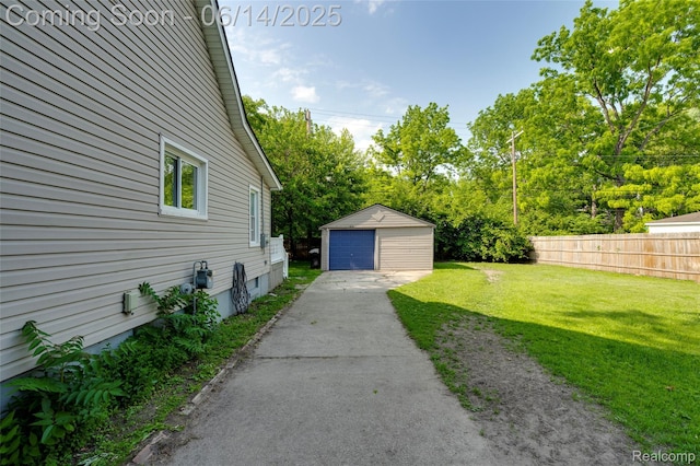 1217 E Madge Ave, Hazel Park, MI 48030 - view of yard with asphalt driveway, a garage, an outdoor structure, and view of wooded area