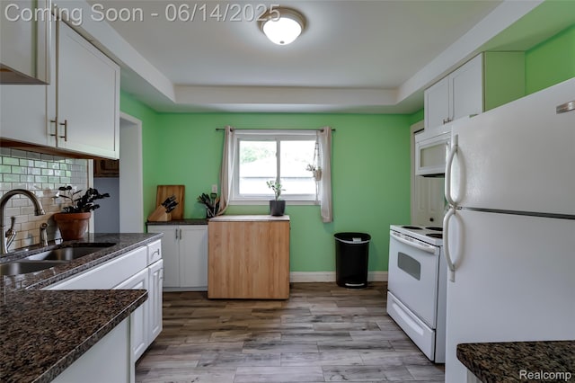 1217 E Madge Ave, Hazel Park, MI 48030 - kitchen with white appliances, white cabinets, decorative backsplash, dark stone countertops, and light wood-style floors