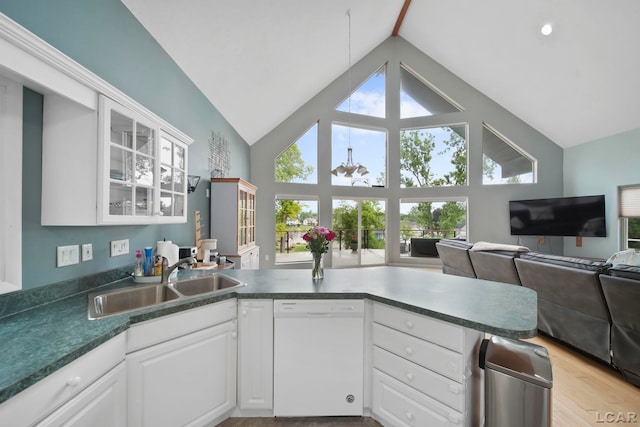 13832 Grandview Dr, Cement City, MI 49233 - kitchen featuring white dishwasher, open floor plan, white cabinetry, glass insert cabinets, and high vaulted ceiling