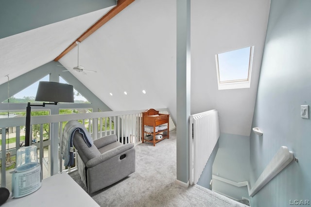 13832 Grandview Dr, Cement City, MI 49233 - carpeted living area with a skylight, high vaulted ceiling, radiator heating unit, a ceiling fan, and beamed ceiling