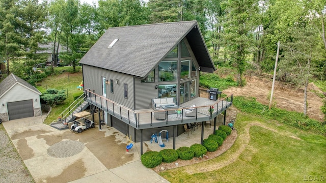 13832 Grandview Dr, Cement City, MI 49233 - view of front of house featuring a wooden deck, view of scattered trees, an outbuilding, roof with shingles, and a front yard