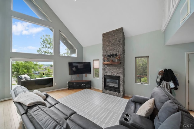 13832 Grandview Dr, Cement City, MI 49233 - living room with high vaulted ceiling, a fireplace, and light wood-type flooring