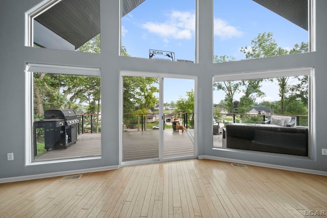 13832 Grandview Dr, Cement City, MI 49233 - entryway with hardwood / wood-style floors, plenty of natural light, and a towering ceiling