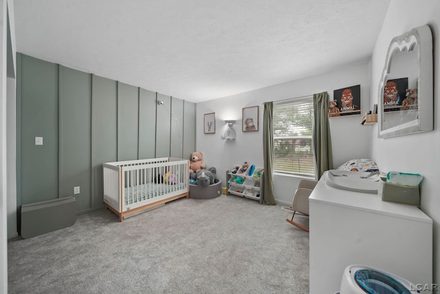 13832 Grandview Dr, Cement City, MI 49233 - carpeted bedroom featuring a nursery area and a textured ceiling
