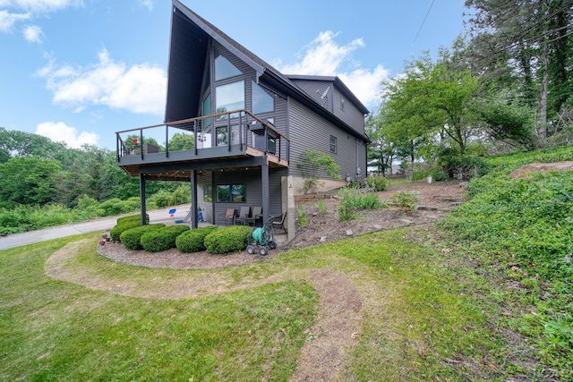 13832 Grandview Dr, Cement City, MI 49233 - rear view of house with a wooden deck, a patio, and a yard
