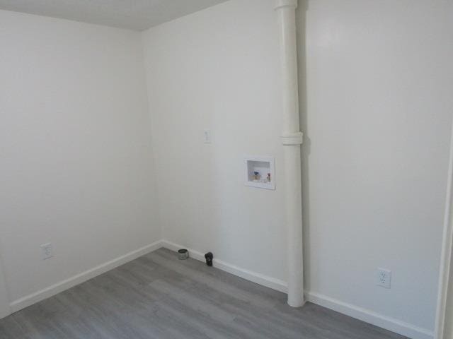 516 Cedar St, Owosso, MI 48867 - laundry room featuring washer hookup and wood finished floors