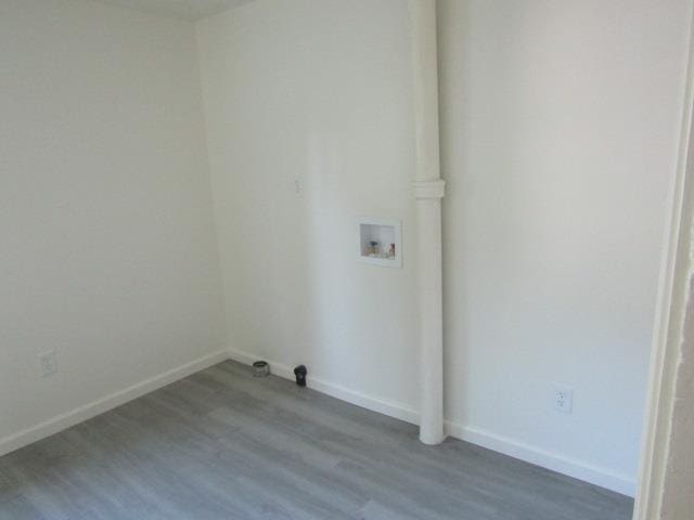 516 Cedar St, Owosso, MI 48867 - laundry room with washer hookup and wood finished floors