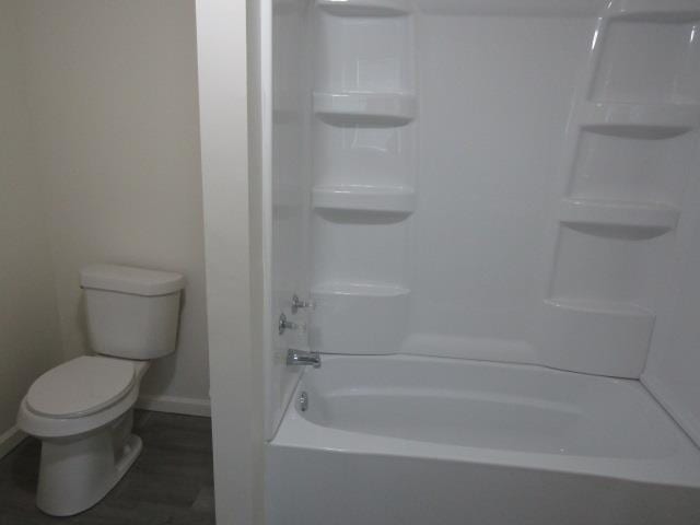 516 Cedar St, Owosso, MI 48867 - bathroom featuring baseboards and shower / washtub combination