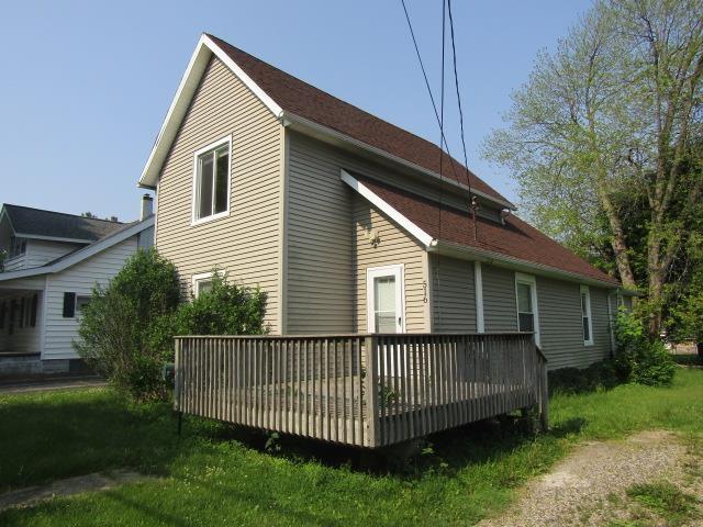 516 Cedar St, Owosso, MI 48867 - view of side of property featuring a wooden deck