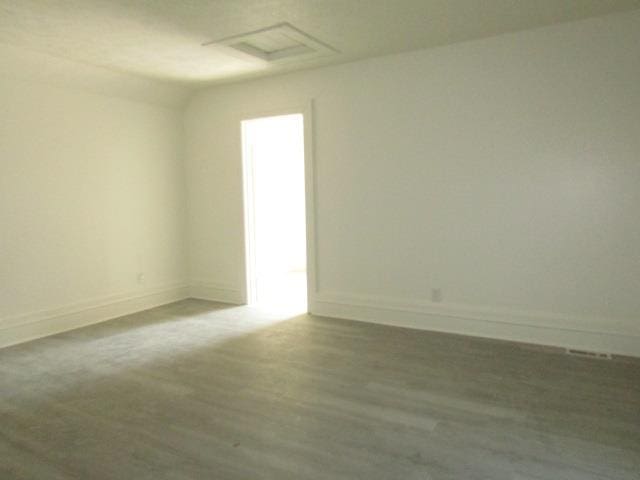 516 Cedar St, Owosso, MI 48867 - unfurnished room with wood finished floors and attic access