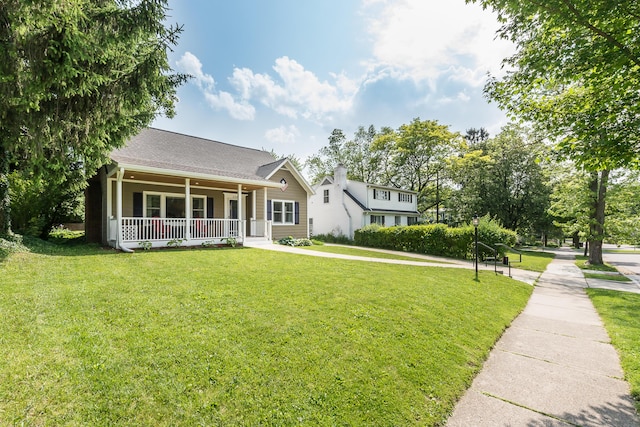 2104 Winchell Dr, Ann Arbor, MI 48104 - view of front of house with covered porch, a front yard, and a shingled roof