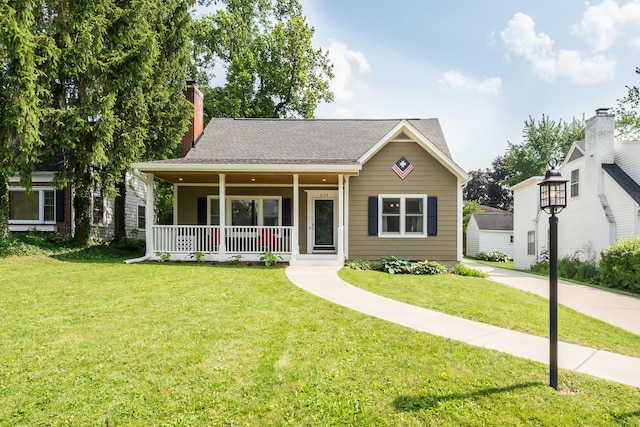 2104 Winchell Dr, Ann Arbor, MI 48104 - view of front facade featuring a porch, a front yard, a chimney, and roof with shingles