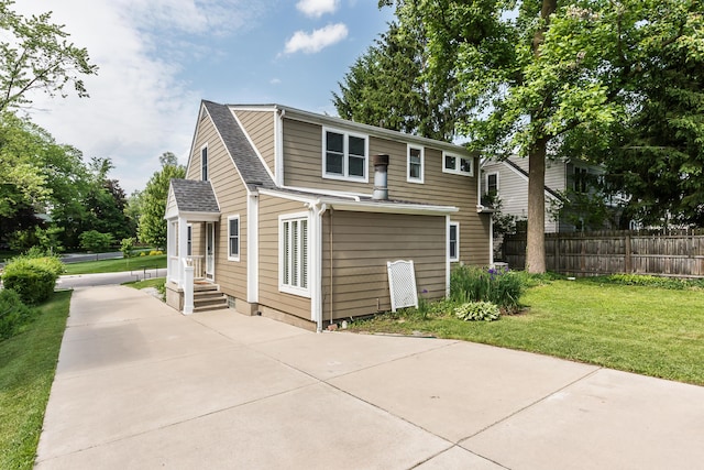 2104 Winchell Dr, Ann Arbor, MI 48104 - back of house featuring a shingled roof and driveway