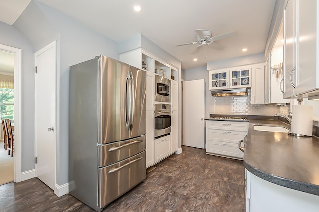 2104 Winchell Dr, Ann Arbor, MI 48104 - kitchen featuring stainless steel appliances, dark countertops, under cabinet range hood, ceiling fan, and white cabinetry