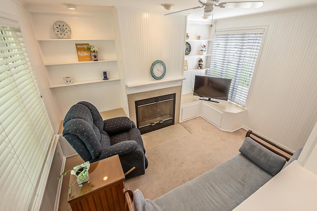 2104 Winchell Dr, Ann Arbor, MI 48104 - carpeted living room featuring a fireplace, a ceiling fan, ornamental molding, and built in shelves