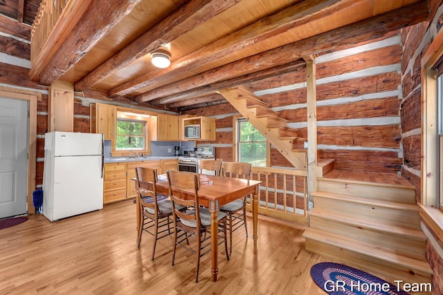 8607 S Ferris Ave, Newaygo, MI 49337 - dining room featuring light wood-type flooring, stairway, and a wood ceiling with exposed beams