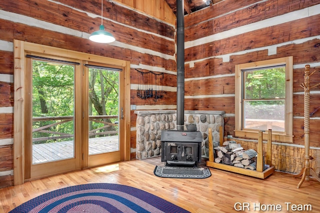 8607 S Ferris Ave, Newaygo, MI 49337 - living area featuring a wood stove, wood walls, and wood finished floors