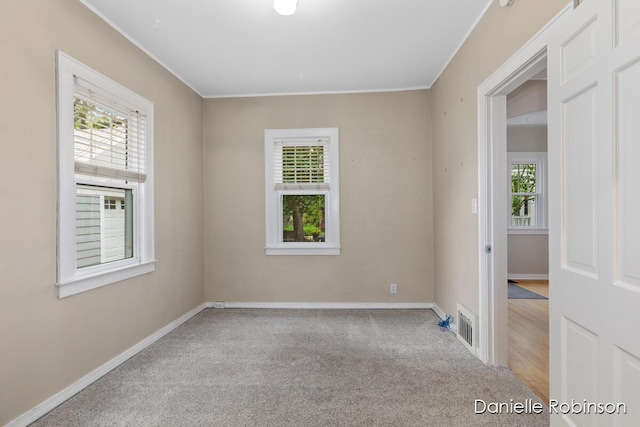 1448 Hall St SE, Grand Rapids, MI 49506 - carpeted spare room with baseboards and crown molding