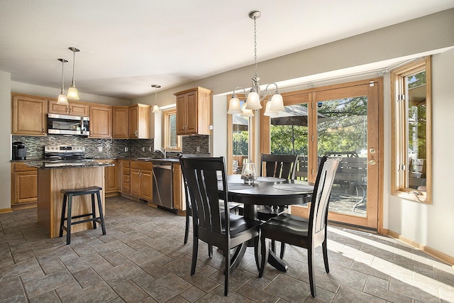 78 Capercaillie Ln, Battle Creek, MI 49014 - dining space with plenty of natural light, a chandelier, and stone tile floors