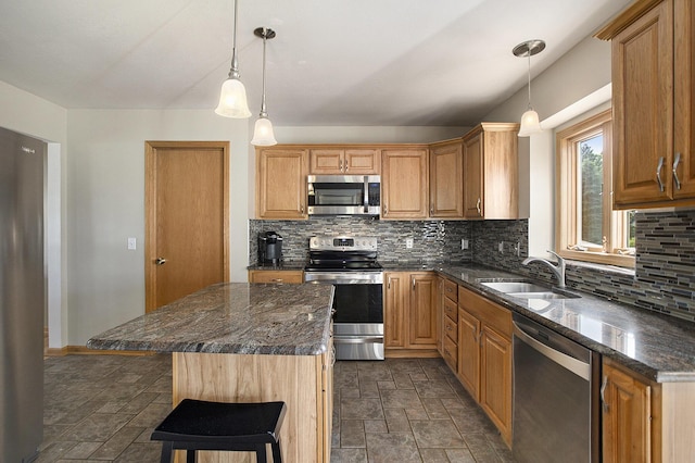 78 Capercaillie Ln, Battle Creek, MI 49014 - kitchen with stainless steel appliances, decorative backsplash, stone finish flooring, dark stone countertops, and a kitchen island