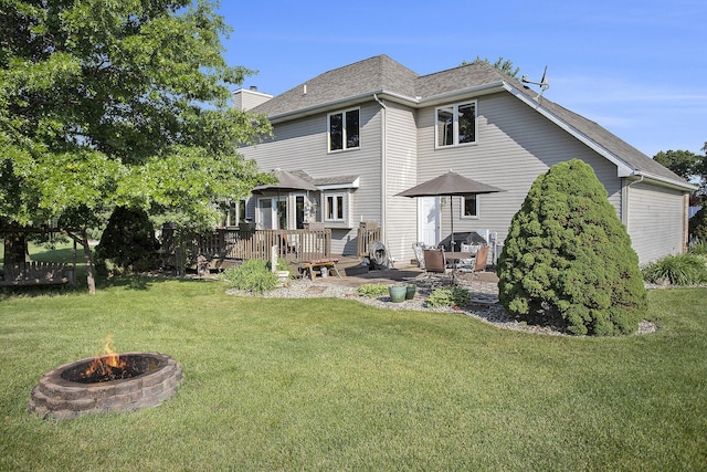 78 Capercaillie Ln, Battle Creek, MI 49014 - back of property featuring a fire pit, a wooden deck, a yard, and a chimney