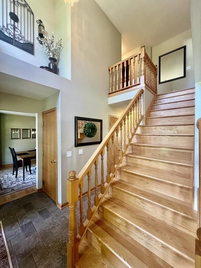 78 Capercaillie Ln, Battle Creek, MI 49014 - stairway featuring a towering ceiling and stone tile floors